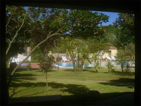 vire of the gounds and swimming pool from the master bedroom at the sardinia villa