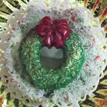 white coconut wreath cookie with green decoration